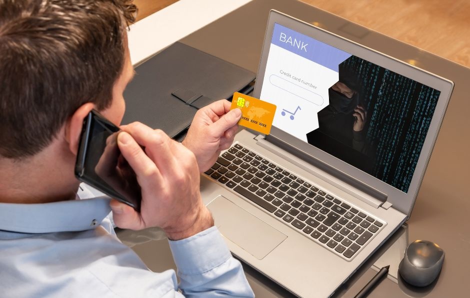 Man using credit card on laptop